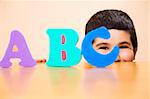 child learning the ABC's. The focus i son the his eyes