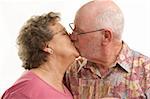 Happy Senior Couple kissing while holding Champagne glasses.