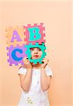 child learning the ABC's. The focus is on her eyes