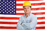 Patriotic construction worker standing in front of an American flag.  Photographed in front of flag, not composite image.