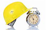 alarm clock and helmet on white background