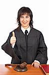 A female judge in a courtroom, success gesture. Shallow depth of field