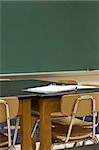 a picture of desks and chalkboard in school classroom