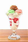 Delicious multi flavor ice cream glass on wooden background. Shallow depth of field