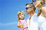 view of young family hanging out in summer environment.