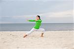 attractive woman doing exercise on the beach