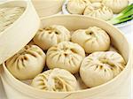 Baozi are steamed buns filled with ground meat and cabbage.