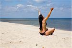 attractive brunette woman relaxing on beach