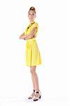 Fashion dressed beautiful girl in yellow dress isolated on white background