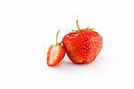 One whole and one half of tasty ripe red strawberry isolated on the white background