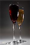 Two glasses with wine on a dark background