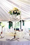 Dinner table setting at a banquet with roses on a chandelier 2