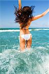 Beautiful young woman having fun on the beach