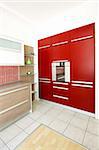 New contemporary red kitchen with metallic oven