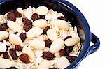 a bowl of oatmeal with raisins and almonds - healthy diet
