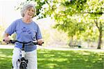 Senior woman on cycle ride in park