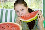 Long hair teen girl with a piece of watermelon in her hands