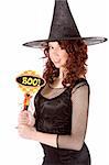 Portrait of Hispanic teenager girl in black Halloween hat and fishnet dress holding "boo!" sign