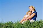 Woman and little girl enjoying the late summer sunshine outdoors