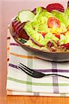 Mediterranean salad with lettuce tomatoes cucumber and beet. Shallow depth of field