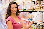 Woman grocery shopping in supermarket