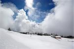 Mountain panorama during sunny day in Alps with lots of new powder snow