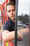 Male firefighter sitting in the cab of a fire engine