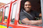 Male firefighter sitting in the cab of a fire engine