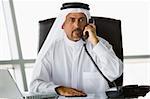 A Middle Eastern businessman talking on the phone