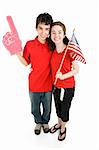Attractive teen couple supporting their favorite sports team or political party.  Full body isolated on white.