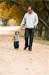 father and son walking in park