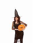 Portrait of young Hispanic woman in black Halloween costume (fishnet dress) holding carved pumpkin (jack-o'-lantern) in hands