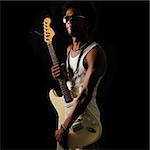 Portrait of young trendy african man holding electric guitar - isolated
