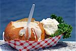 Clam chowder in a sourdough bread bowl on a wooden fishing dock