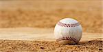 one baseball on home plate at a sports field