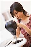 Woman in computer room sitting by small punching bag