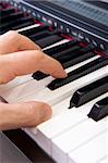 Close-up of hands playing the piano.