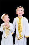 Cute little 3yr and 5yr old boys wearing traditional Arabian thobes for the purpose of asking for Ramadan treats.