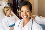 Doctor Standing In Her Patients Room