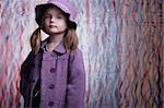 Gorgeous little fashion model posing in violet coat.