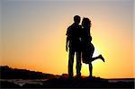 happy couple by the sea silhouette