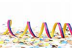 Confetti and ribbons on white background. Shallow depth of field