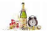 Champagne glass ready to bring in the New Year, with clock, ribbons and confetti