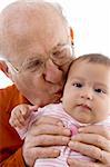 old man kissing the cute baby with white background