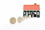 Row of euro coins rolling into a house - on white background