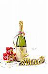 Champagne bottle with empty glass, gisfts, ribbons and confetti for celebrations