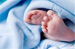 cute baby feet in blue blanket