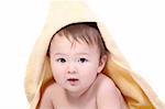 bright portrait of adorable baby wrapped in towel