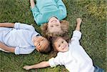 Three Little Children Having Fun in the Grass