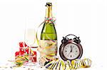 Champagne bottle with glass, ribbons and confetti for New Year celebration